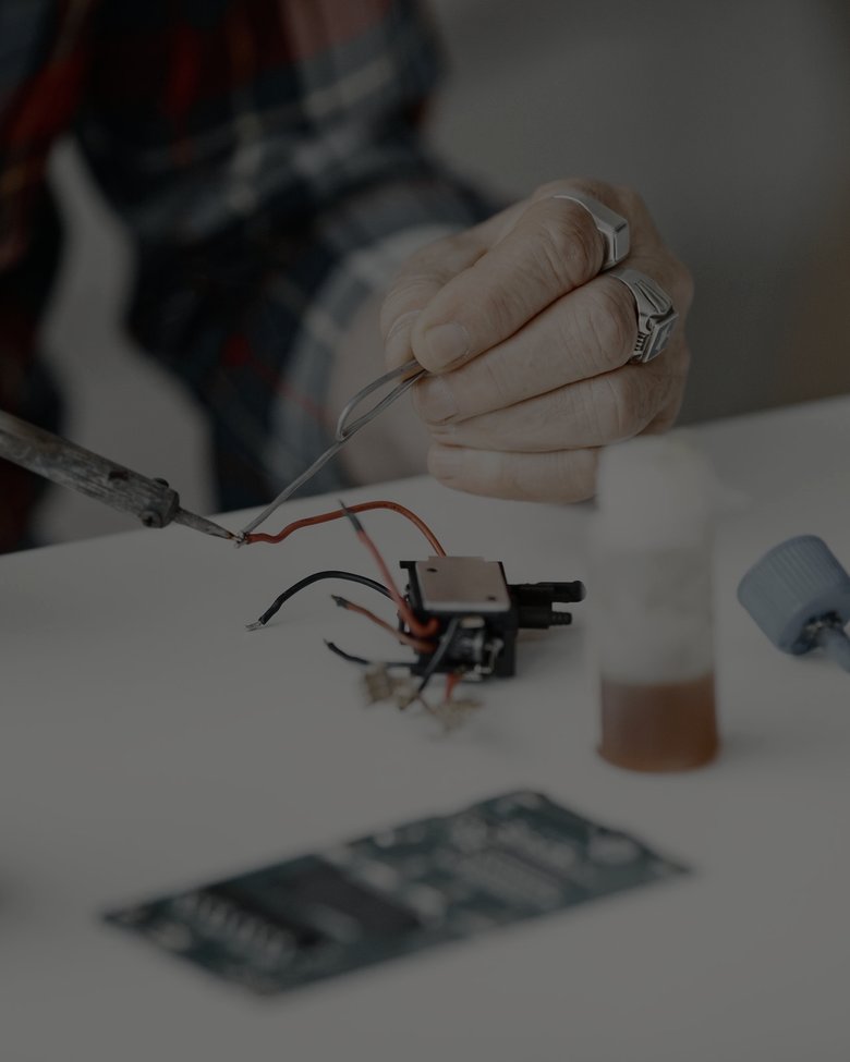 Bench · hands working on a circuit board, application reference